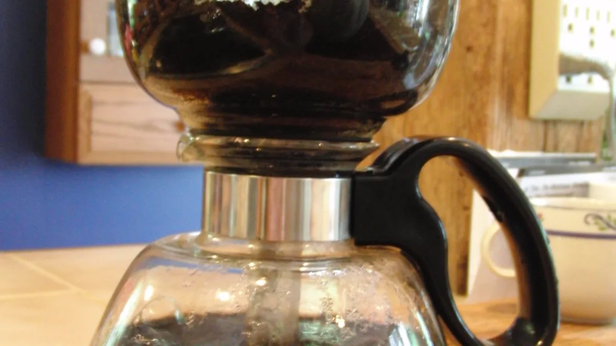 Testing Total Dissolved Solids and Mineral Carbonate Hardness for Coffee A small home water testing kit measuring total dissolved solids and mineral drops beside coffee beans