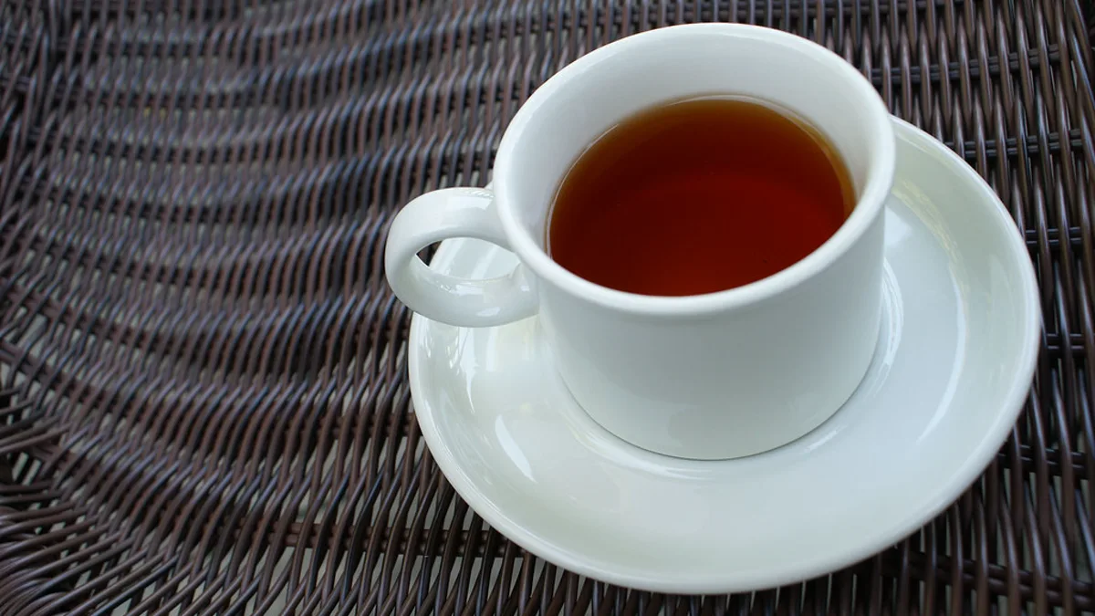 Pristine Specialty Black Coffee Brewed with Balanced SCA Water Parameters A translucent cup of black specialty coffee showing golden amber highlights under natural window light