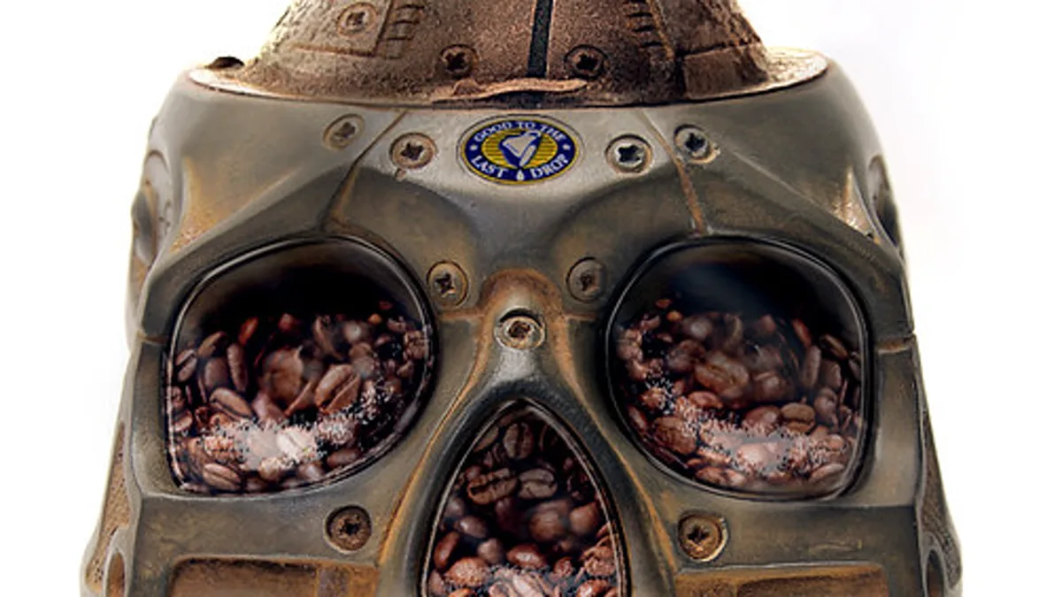 Disassembled parts of a domestic electric coffee grinder including hopper, upper burr carrier, and collection bin